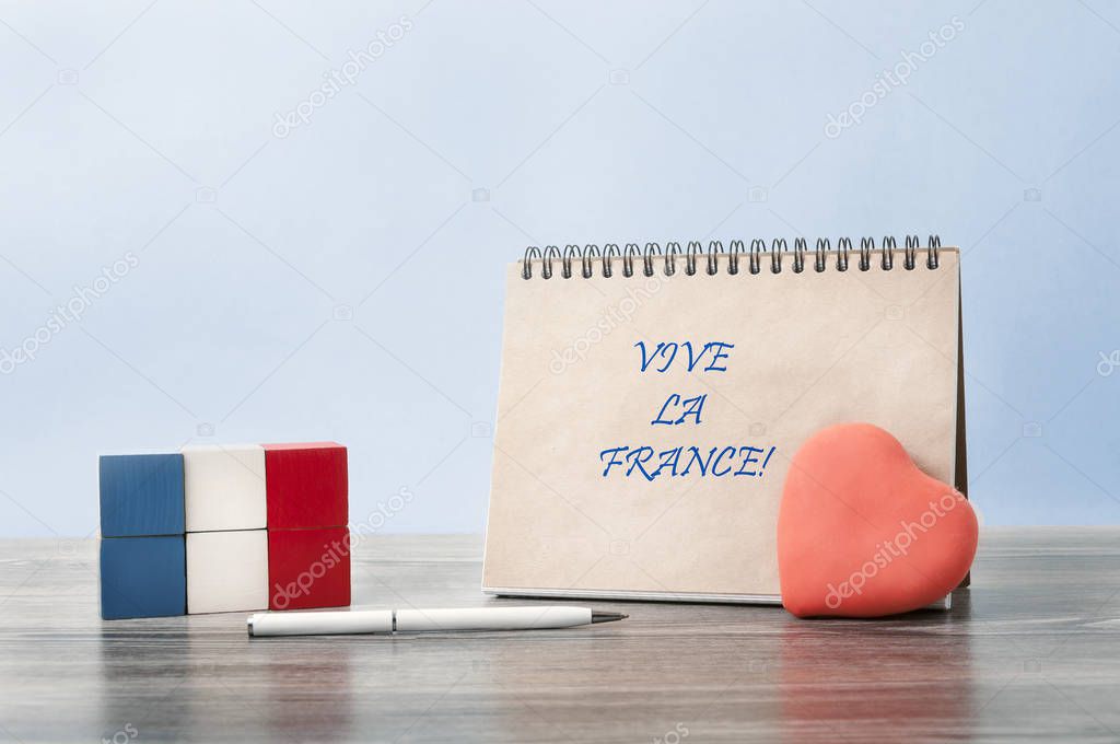   Congratulations on Bastille day. A heart is attached to an open Notebook. Next to it is the flag of France, made up of cubes.