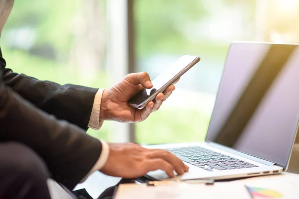 Geschäftsleute arbeiten mit Telefon und Laptop Stockbild