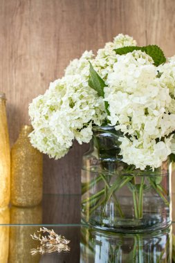 Gözlüklü gül kırmızısı şarap. Arka planda çiçekler olan bir şişe gül şarabı. Prosecco.