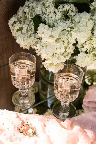 Rose blush wine in glasses. Bottle of rose wine with flowers on background. Prosecco.