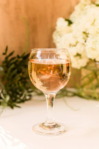 Rose blush wine in glasses. Bottle of rose wine with flowers on background. Prosecco.