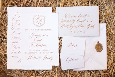 Wedding details flat lay on wooden background. Wedding invitation. Wedding bouquet. Mock up. Envelope. Copy space.