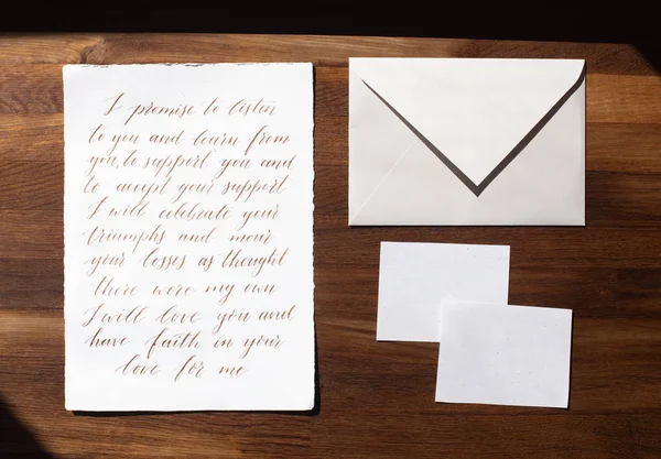Wedding details flat lay on wooden background. Wedding invitation. Wedding bouquet. Mock up. Envelope. Copy space.