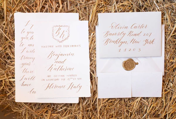 Wedding details flat lay on wooden background. Wedding invitation. Wedding bouquet. Mock up. Envelope. Copy space.