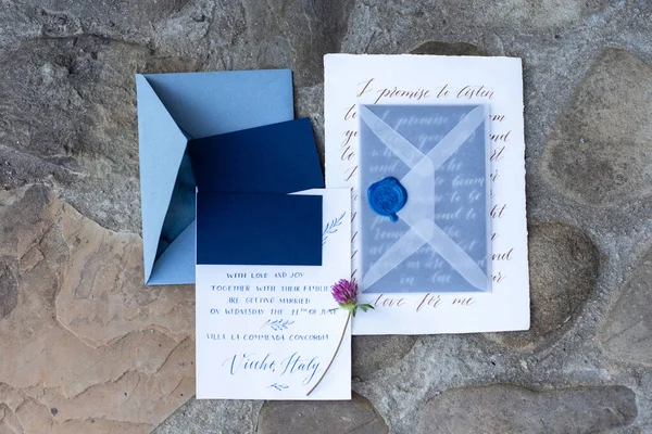 Wedding details flat lay on stone background. Wedding invitation. Ring box. Mock up. Copyspace.