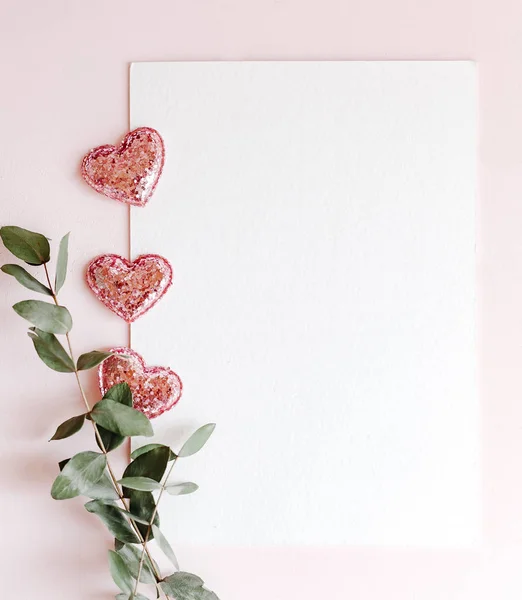 Background with copy space blank on pink background with pink glittered hearts, eucalyptus branch. White paper top view, flat lay, minimal style. Moke up card. — 스톡 사진