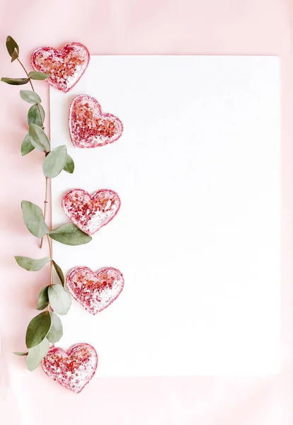 Background with copy space blank on pink background with pink glittered hearts, eucalyptus branch. White paper top view, flat lay, minimal style. Moke up card. — 스톡 사진