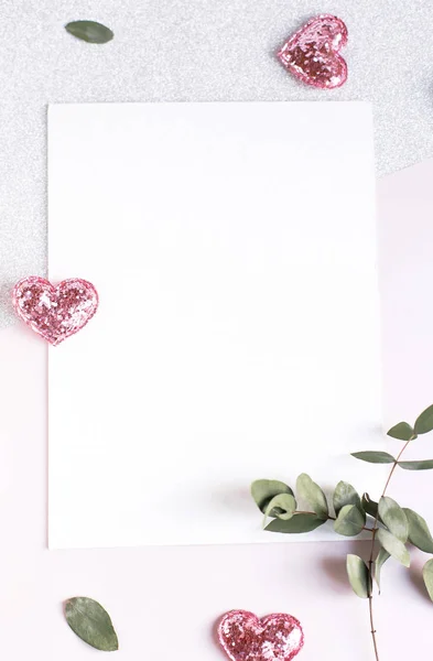 Background with copy space blank on white table with glitter heart, eucalyptus branch, flowers and leafs. White paper top view, flat lay, minimal style. Moke up card. — 스톡 사진