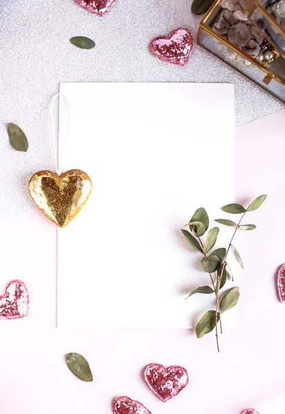 Background with copy space blank on white table with glitter heart, eucalyptus branch, flowers and leafs. White paper top view, flat lay, minimal style. Moke up card. — 스톡 사진