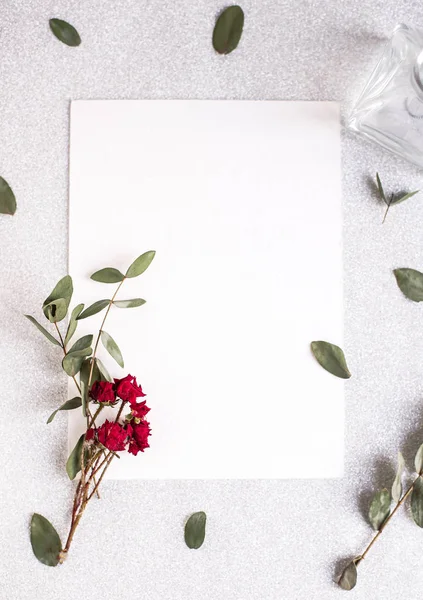 Background with copy space blank on white table with glitter heart, eucalyptus branch, flowers and leafs. White paper top view, flat lay, minimal style. Moke up card. — 스톡 사진