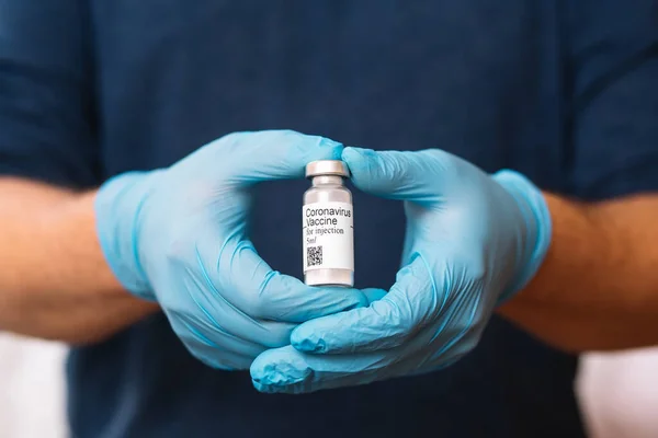 Coronavirus aşısı. Aşısı olan bir doktor. Covid-19 'a karşı Coronavirus aşısı ampulü tutan eller..