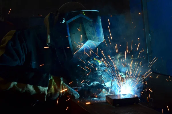 Welders working at the factory made metal