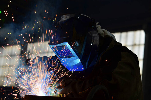 Welders working at the factory made metal