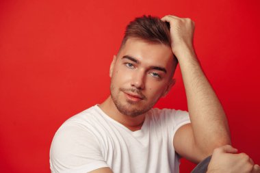 Kırmızı Arkaplanda Stüdyo Adam Moda Portresi. Yakın plan.