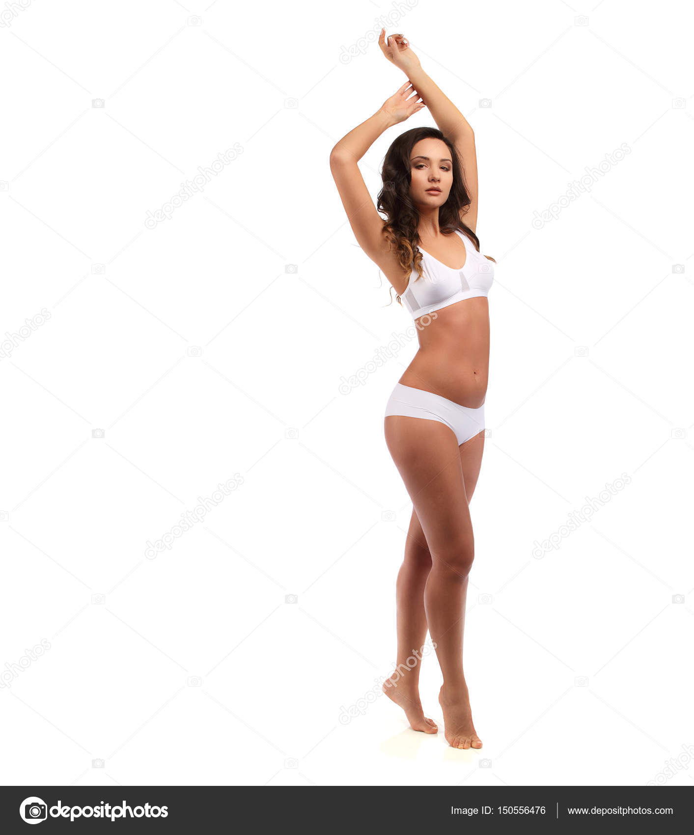 Woman standing in white cotton panties and bra isolated on white, hands up  Stock Photo by ©fenixlive 150556476