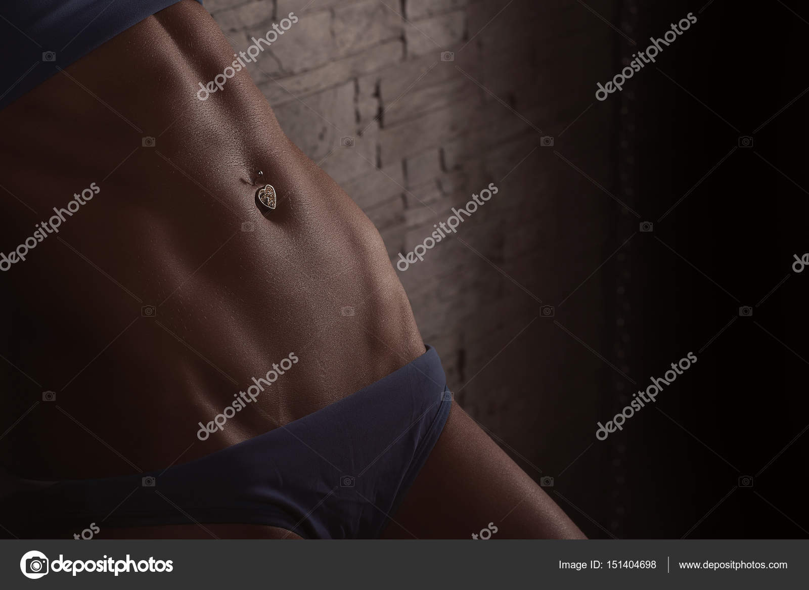 Closeup woman body part in blue panties. Sexy unrecognizable bodybuilder  woman in blue bikini with navel piercing over stone wall background Stock  Photo by ©fenixlive 151404698