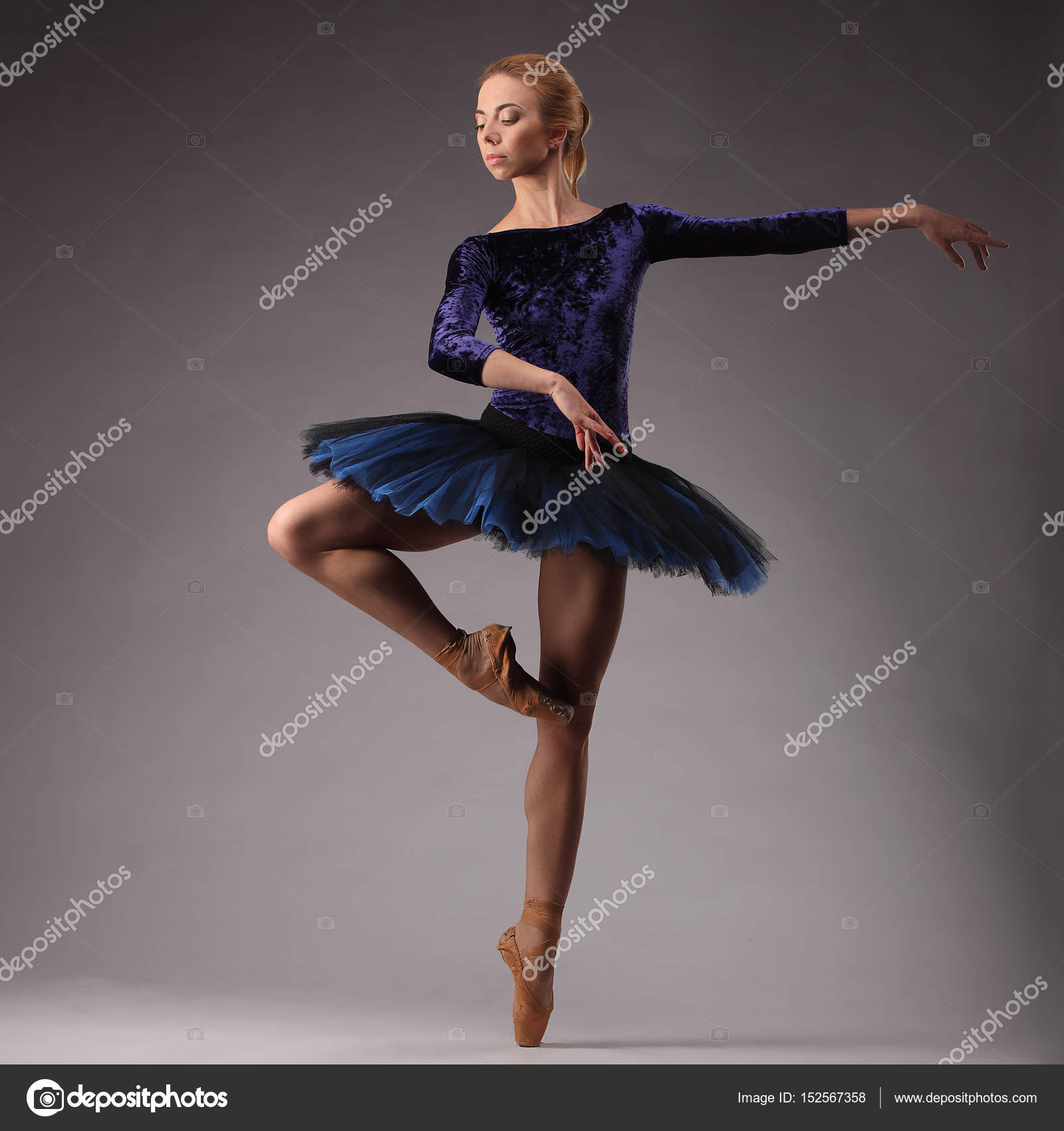 incredibly beautiful ballerina in blue outfit dancing in studio