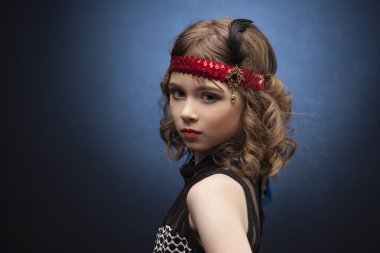 Studio arka plan üzerinde catwalk üzerinde yürüyen güzel küçük model ile Mavi ışıklı. Aggressove bak, kırmızı dudaklar ve parti bir Added Muhteşem Gatsby tarzı giyinmiş