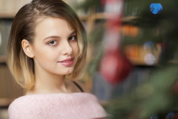 Beautiful fashion model wearing pink in studio on background lighted with green. Christmas — Stock Photo, Image