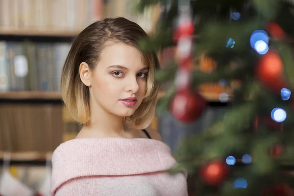Krásná modelka na sobě růžové ve studiu na pozadí svítí zelenou barvou. Vánoční — Stock fotografie