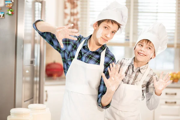 Two brothers in cook hats. — Stock Photo, Image