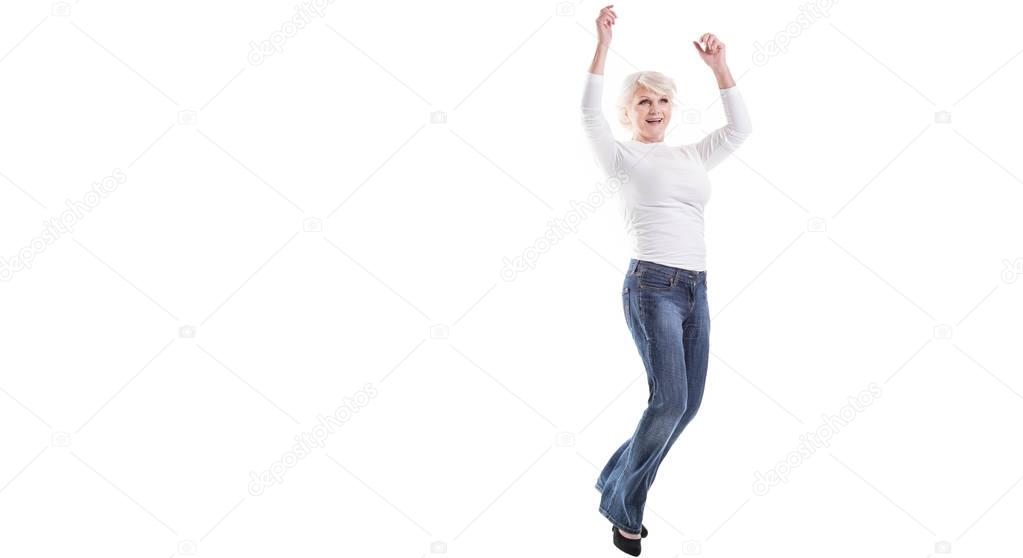 Happy mature woman jumping.