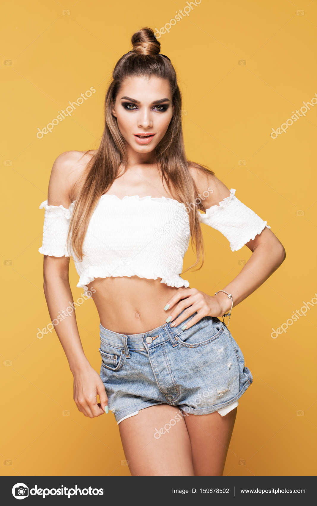 Female model posing on yellow. Stock Photo by ©NeonShot 159878502