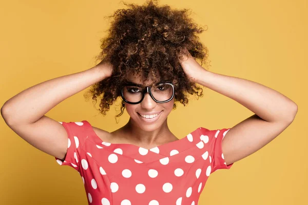 African american girl in eyeglasses on yellow background. — Stock Photo, Image