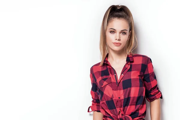 Student girl posing in red checkered shirt. — Stock Photo, Image