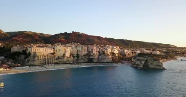 Antenna, drone kilátás nyílik a városra Tropea Calabria-ban. Tengerpart este, naplemente idején. — Stock videók