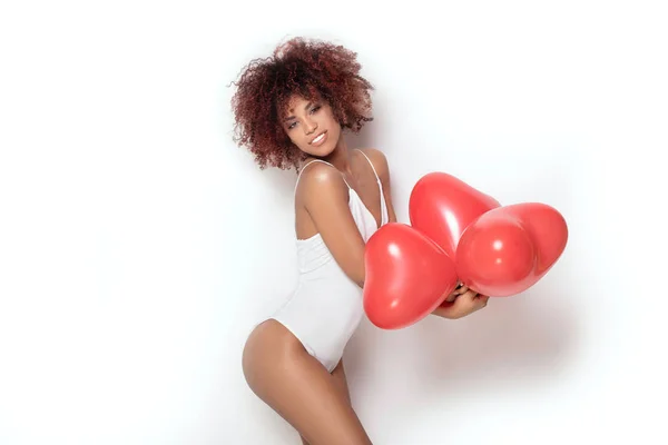 African american girl with heart shaped baloons. — Stock Photo, Image