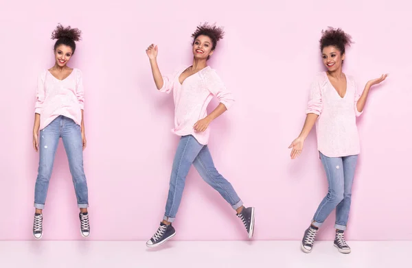 Gelukkig afro meisje met verbazingwekkende glimlach poseren op roze achtergrond. — Stockfoto