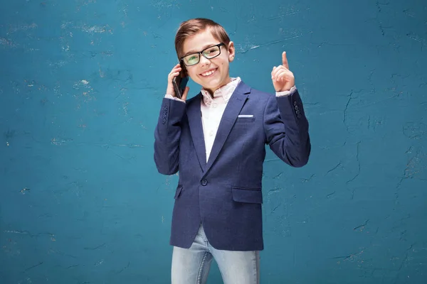 Έξυπνο αγόρι σε γυαλιά μιλάμε από το κινητό τηλέφωνο. — Φωτογραφία Αρχείου