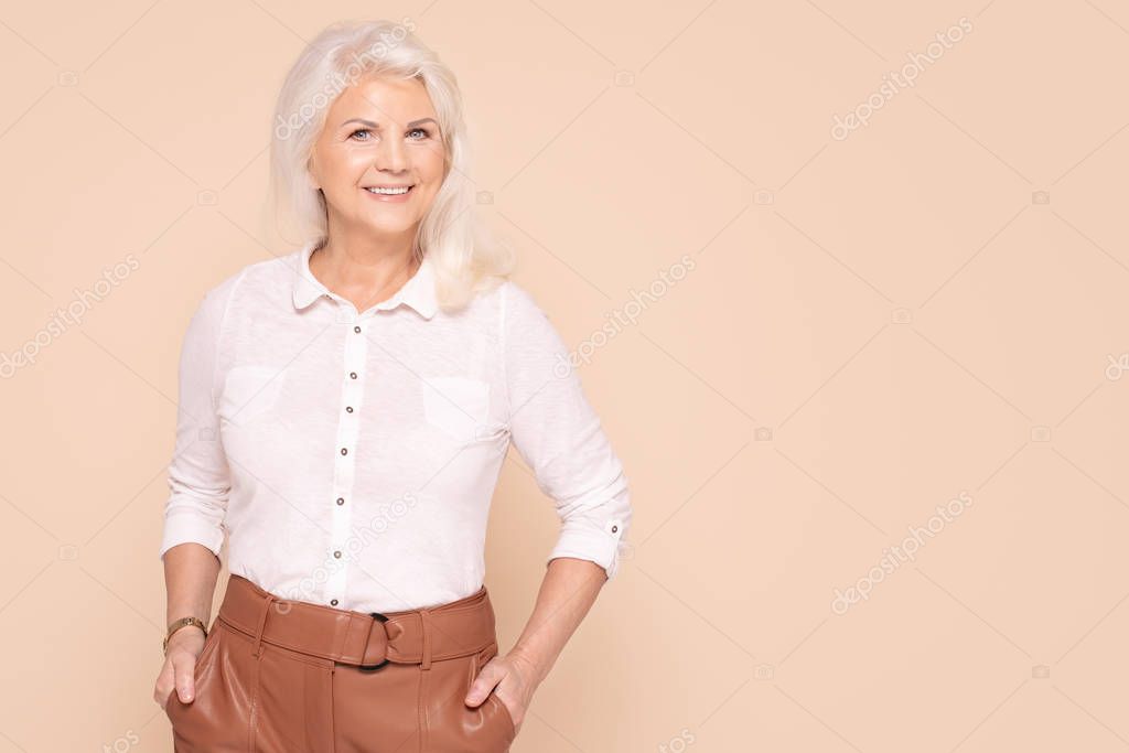 Smiling senior lady in fashionable clothes.