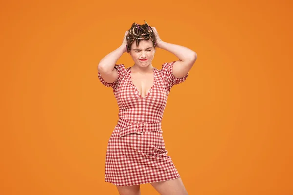 Angry girl with rollers on head. — Stock Photo, Image