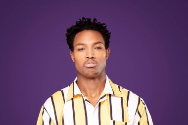 Sad african american man posing in studio.