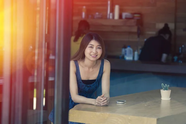 portrait of asia happy woman resting in cafe on holiday