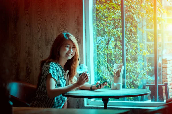 portrait of asia beautiful woman using smartphone in coffee shop
