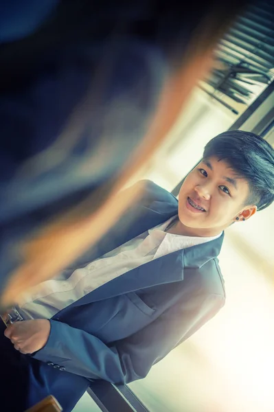 asia young businessman on window in office