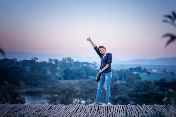 asia tourism woman posing on view point with mountrain