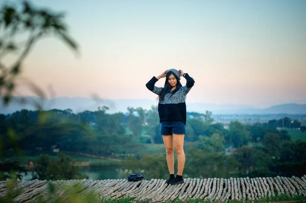 asia woman posing on view point with mountrain