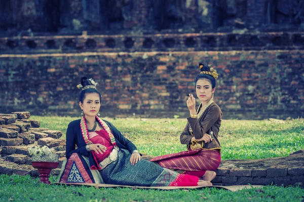 Two ancient beautiful Thai women in vintage dress  sitting — Stock Photo, Image