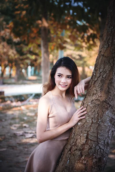 portrait of asia beautiful woman lying tree in park