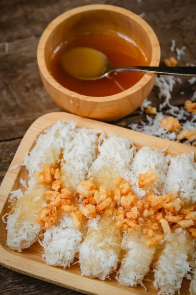 Rice cake with coconut syrup and rice cracker. — Stock Photo, Image