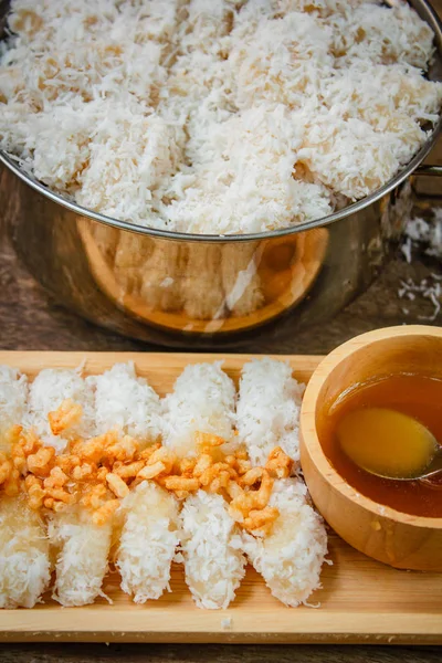 Rice cake with coconut syrup and rice cracker.