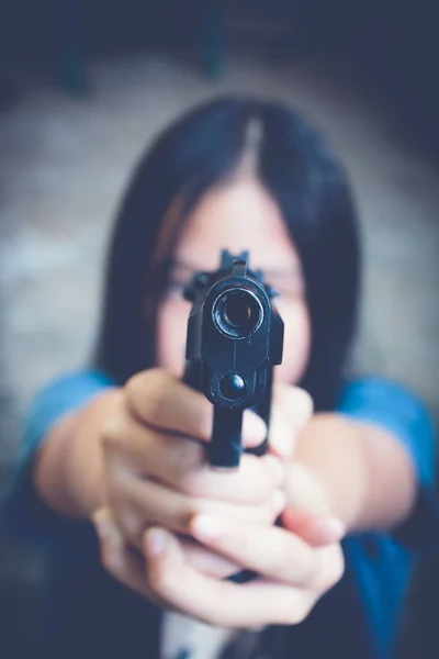 girl pointing a gun at the target