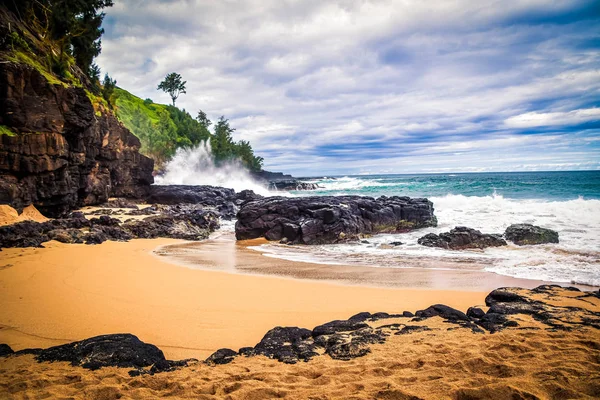 Beach with black rocks in Hawaii