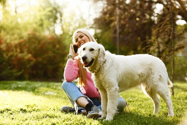 Woman is relaxing with dog — Stock Photo, Image