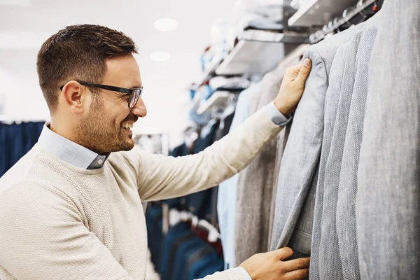 Smiling Young Man Buying Clothes