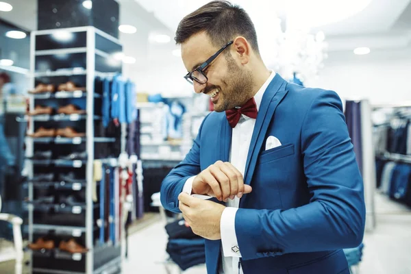 Smiling Young Man Buying Clothes